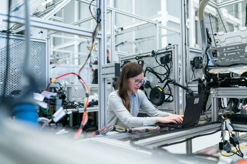 An engineer working on a laptop in a technical test laboratory.